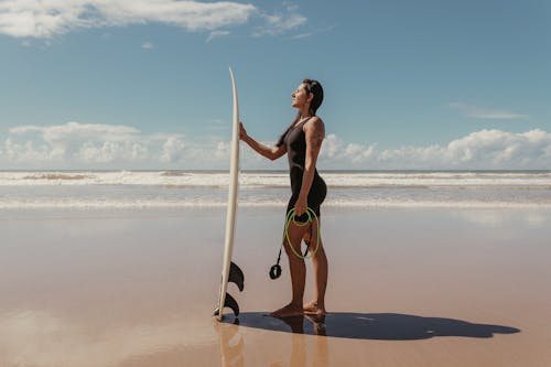 Surfer Checking Her Board Before Going to the Sea