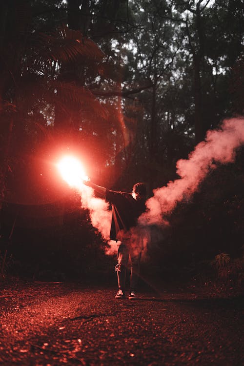 Man with Flare in Forest