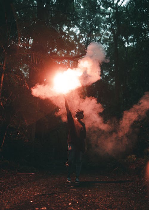 Man with Flare in Forest