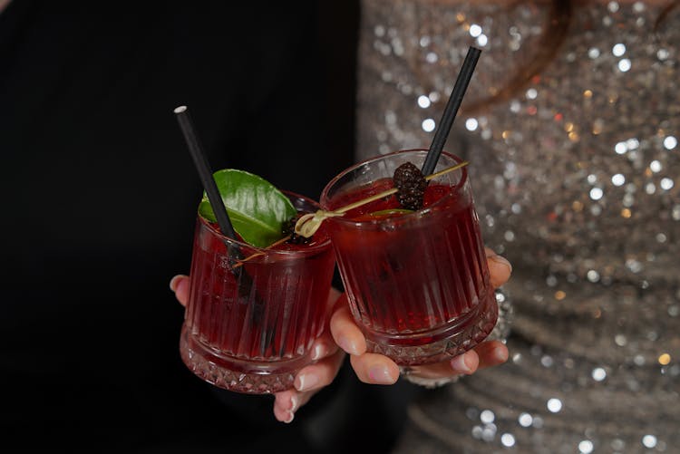 Holding Lowball Glasses With Blackberry Cocktail