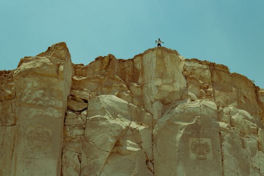 A person standing on top of a rock formation
