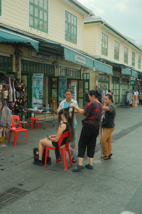 A Woman Having her Hair Done on the Street