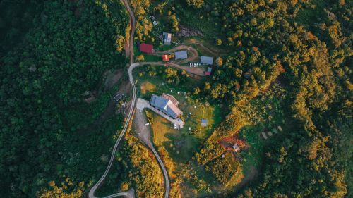 Free Stunning aerial view of a rural village surrounded by lush greenery in Kundasang, Sabah, Malaysia. Stock Photo