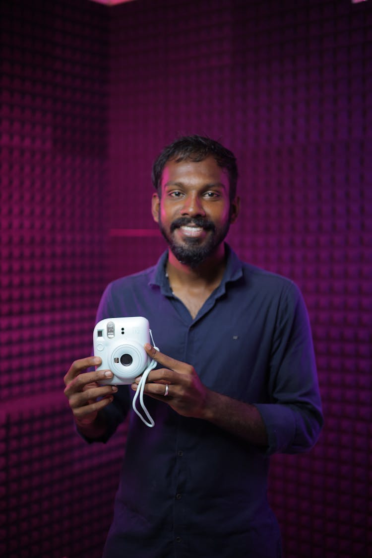 Portrait Of An African Man Holding A White Camera