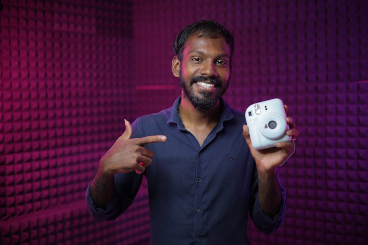 Portrait Of Man Holding White Camera 