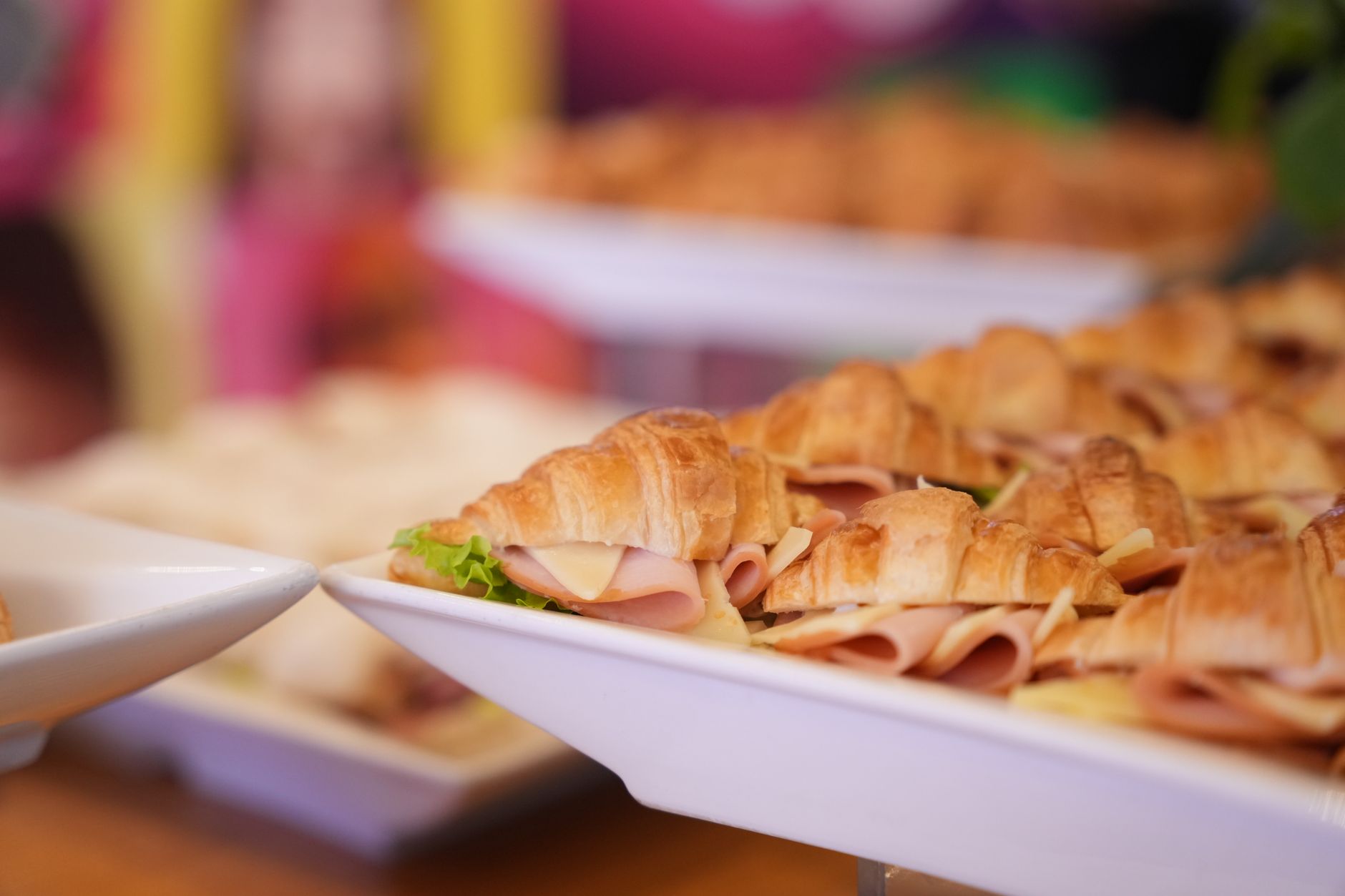 A close-up of fresh ham and cheese croissants on a plate, perfect for dining.
