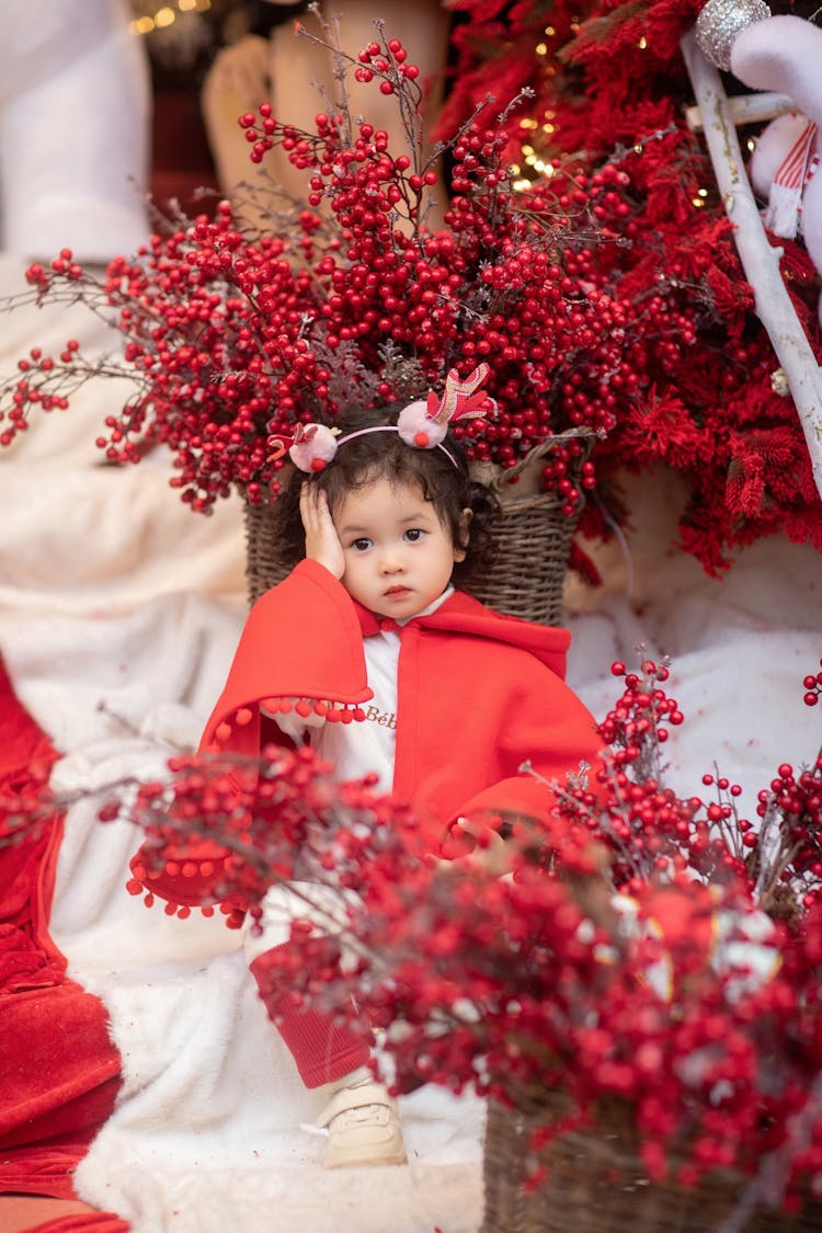 Little Girl Among Christmas Decoration