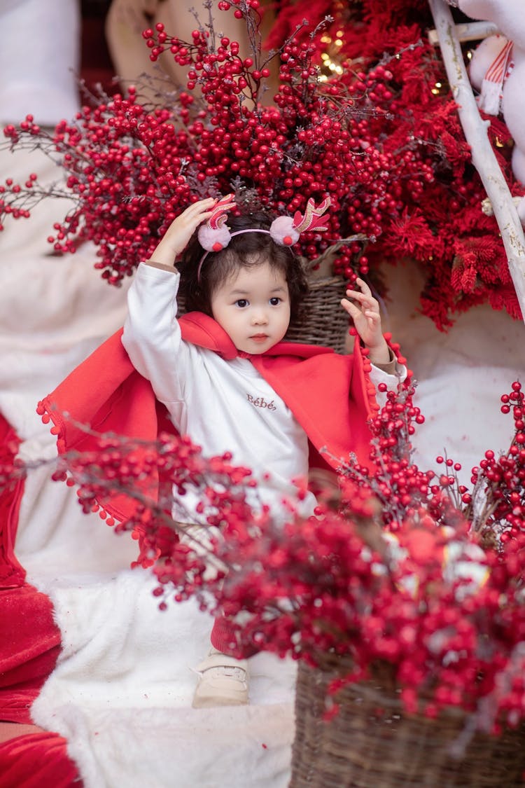 Little Girl Among Christmas Decoration