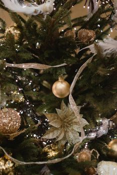 Festive Christmas tree adorned with gold ornaments, lights, and ribbons, creating a warm holiday ambiance.