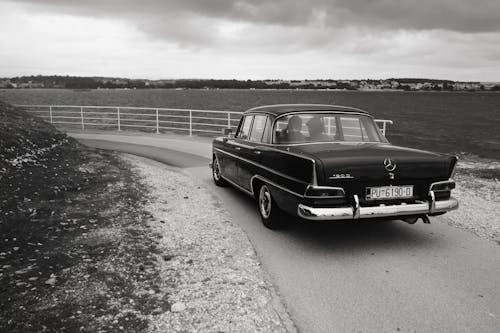 Retro Mercedes Car Driving on Road in Countryside