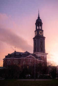 Stunning sunset view of St. Michael's Church in Hamburg, Germany, highlighting its architectural beauty.