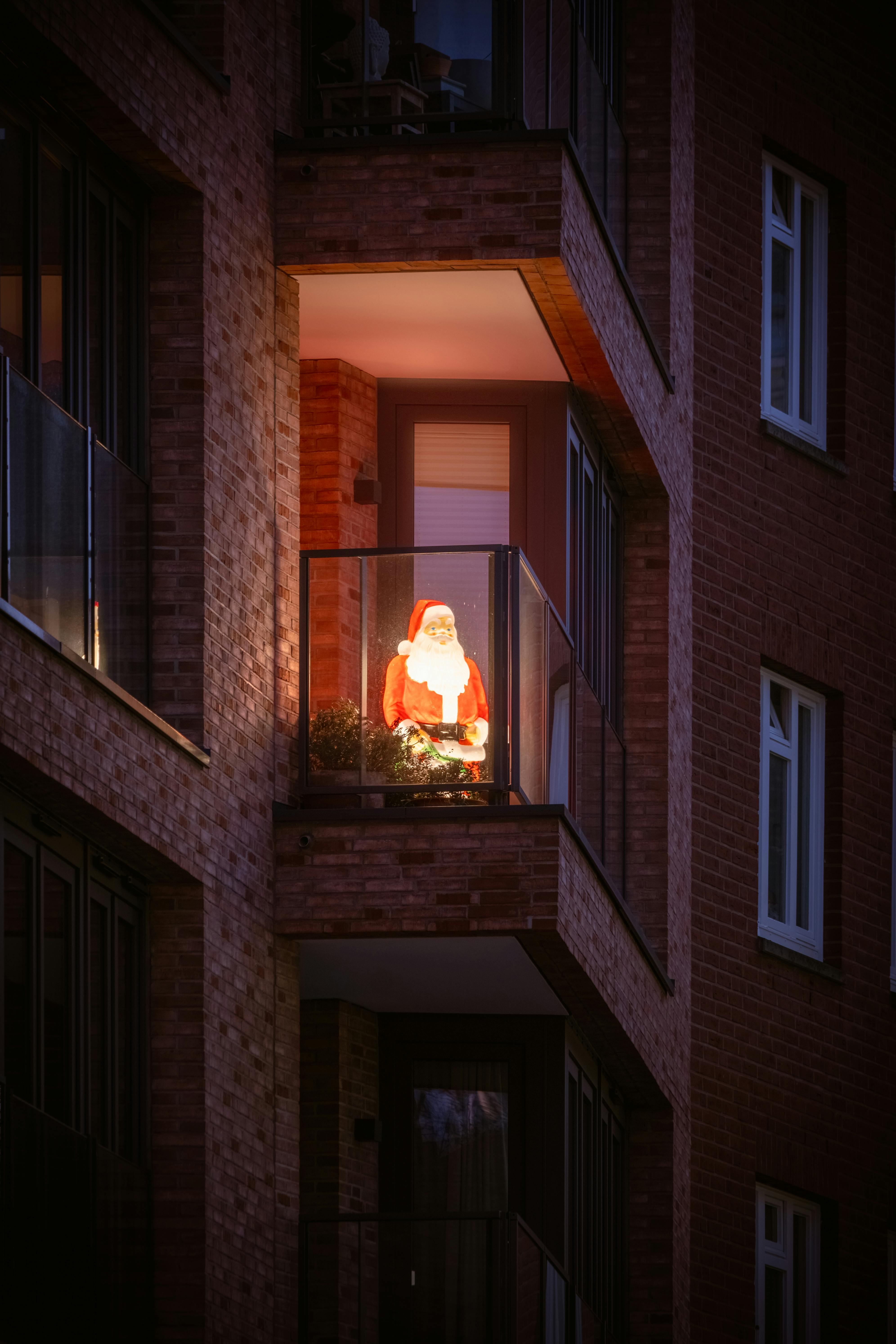 a christmas tree is lit up in a window