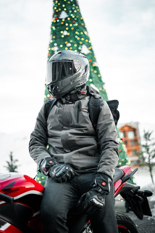 Man in a Helmet in front of a Christmas Tree