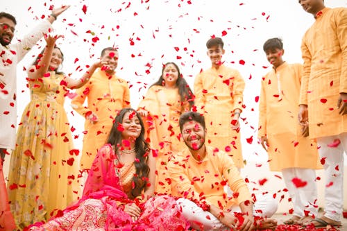Confetti over Smiling Newlyweds in Traditional Clothing