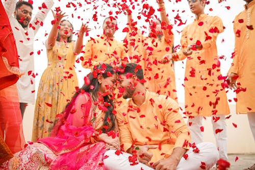 People Throwing Petals on a Couple 