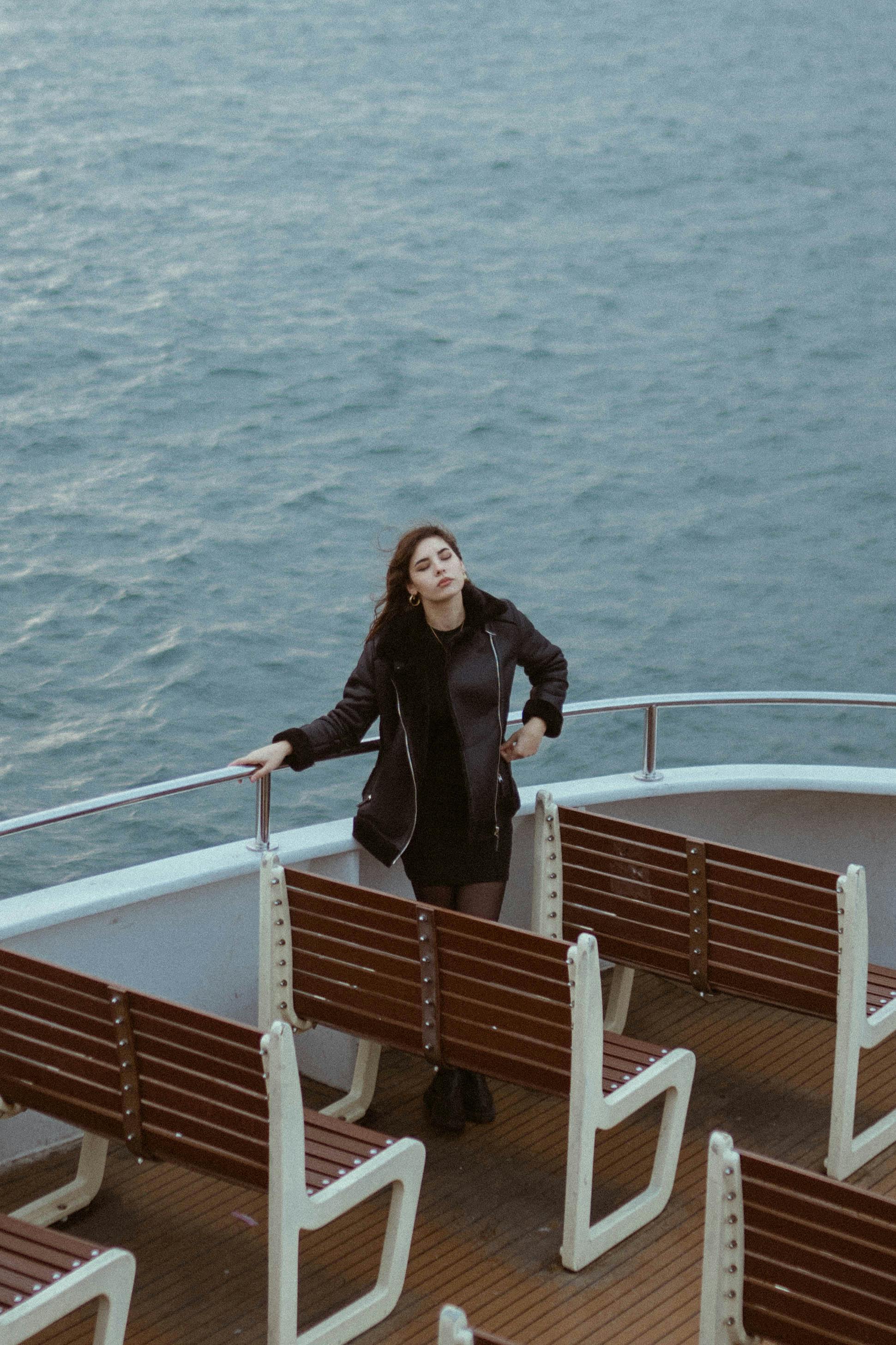 high angle view of a woman on a ferry with brown benches