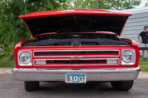 Free A classic red Chevrolet car with hood open, showcasing its engine. Captured outdoors in Nelson, WI. Stock Photo