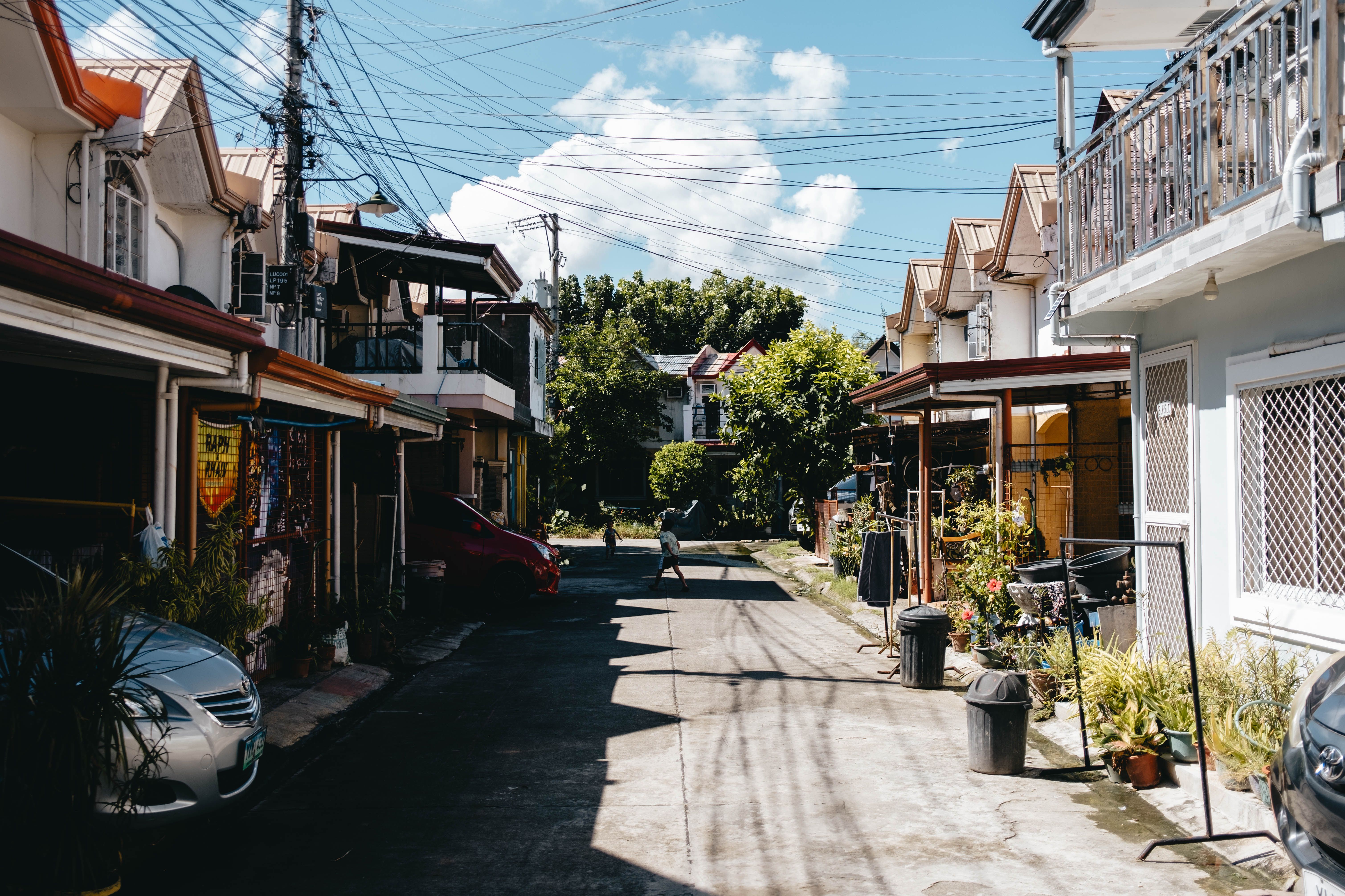 Charming neighborhood street with traditional houses on a sunny day.