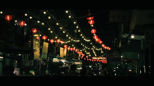 Illuminated Red Lamps over Street