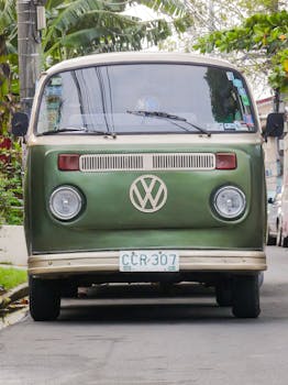 Classic green Volkswagen van parked in an urban street in Manila, showcasing retro style and urban vibe.