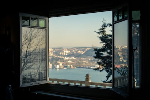 View of a Body of Water and City from a Window on a High Floor 