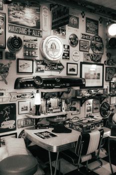 Black and white retro diner interior with car-themed decorations.