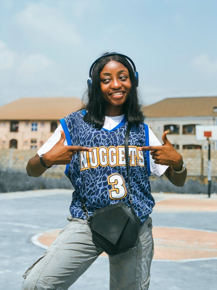 Young Woman In Denver Nuggets Jersey On The Basketball Court