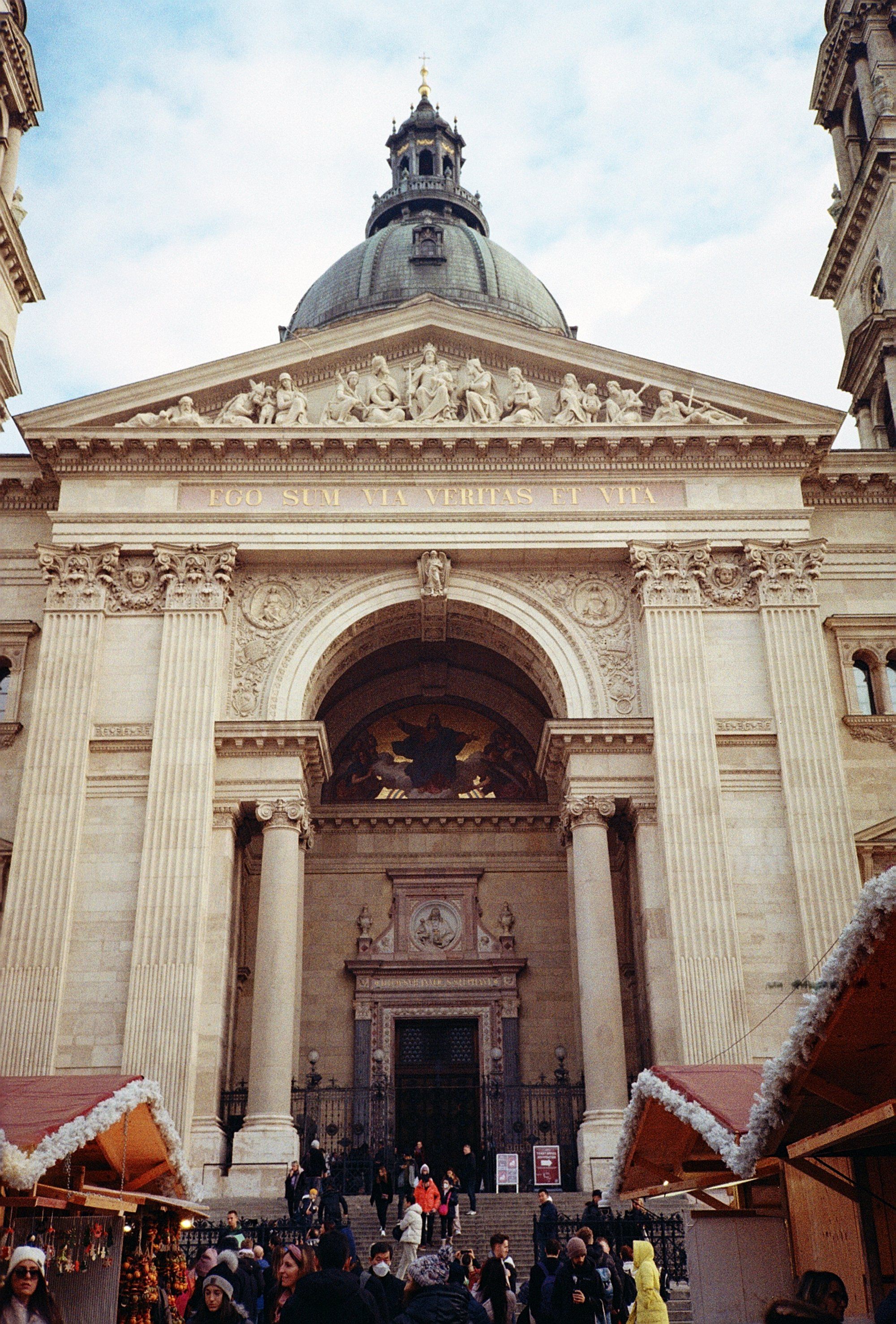 The majestic facade of St Stephen's Basilica in Budapest with urban cityscape.