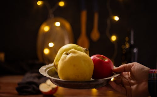 Hand Holding Plate with Fruit