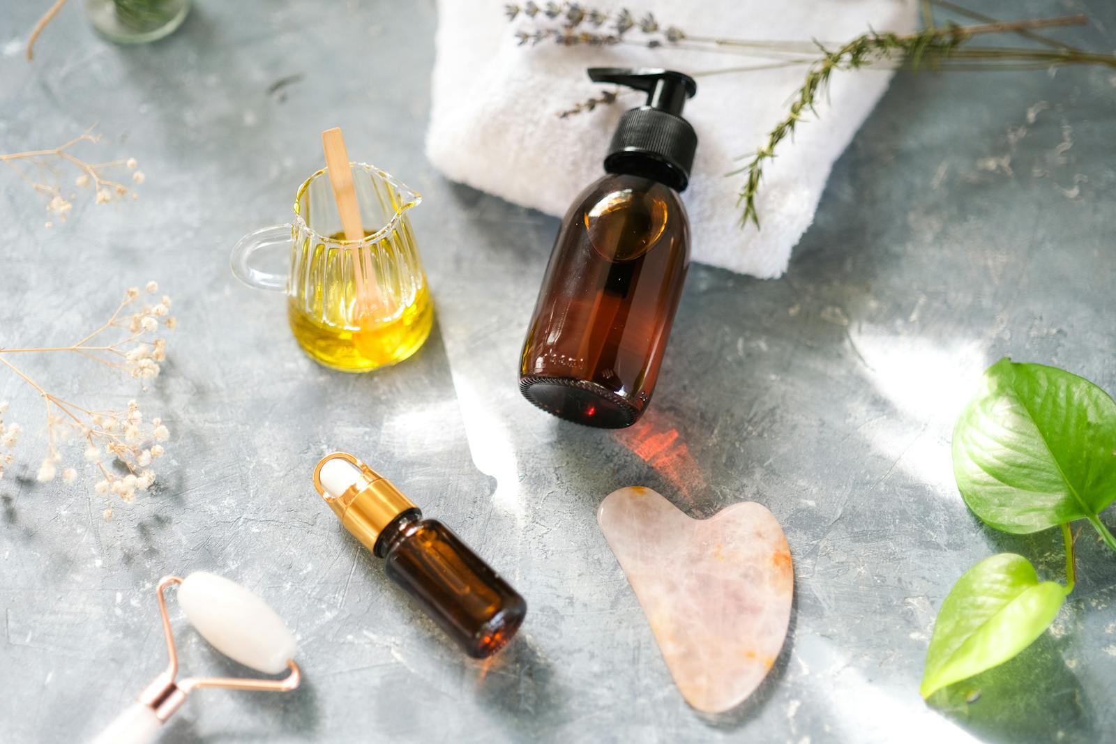 Flat lay of skincare oils and self-care tools for planning new year beauty resolutions
