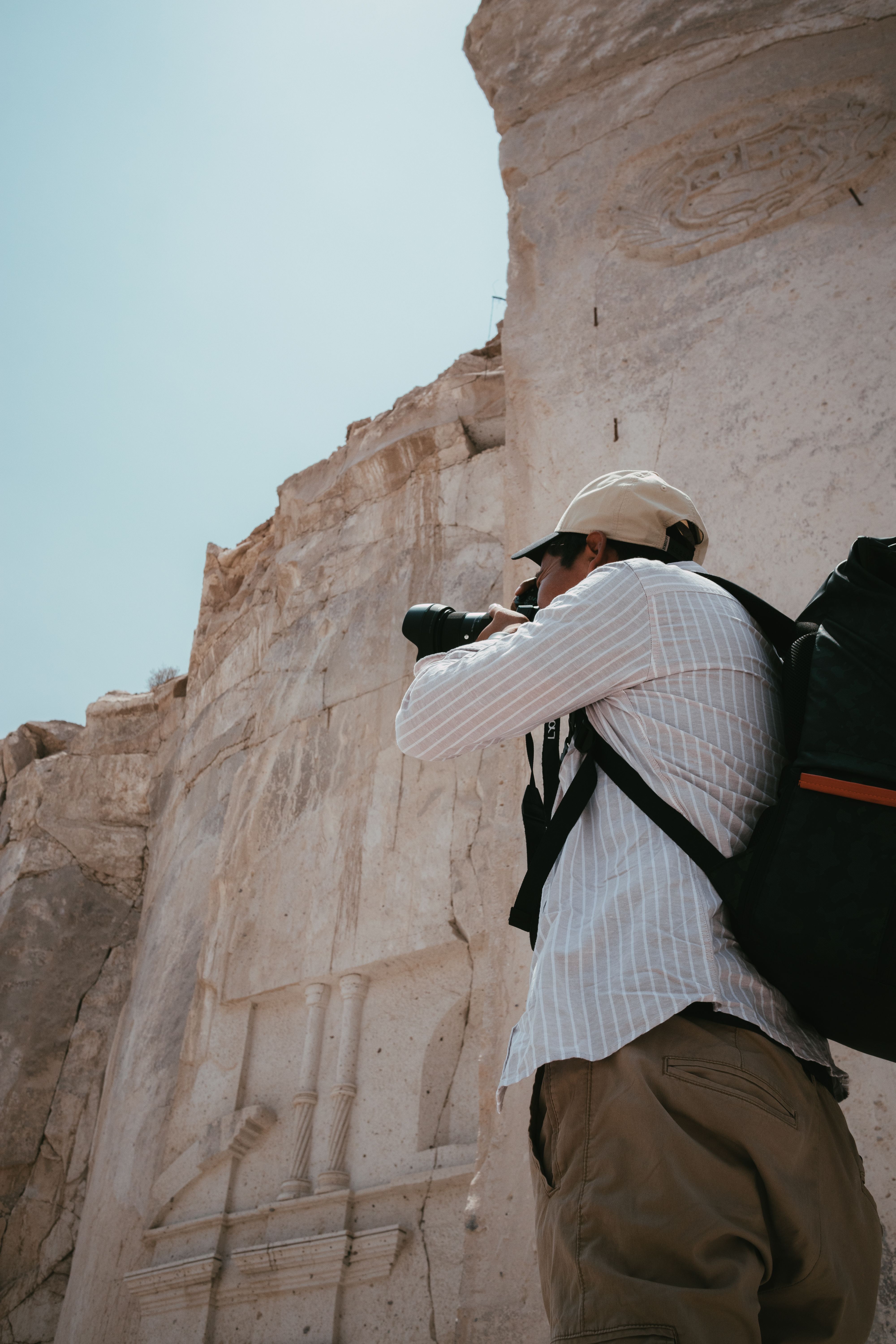 Photographer in Shirt Taking Photo of Cliff · Free Stock Photo