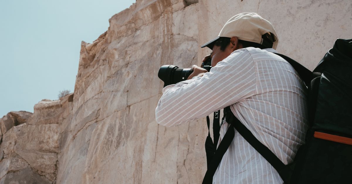 Cliff Reed Photography Photographer in Shirt Taking Photo of Cliff · Free Stock Photo