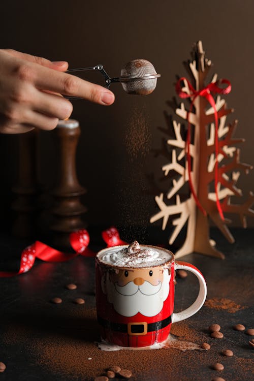 Adding Cocoa Powder to Coffee Cup for Christmas