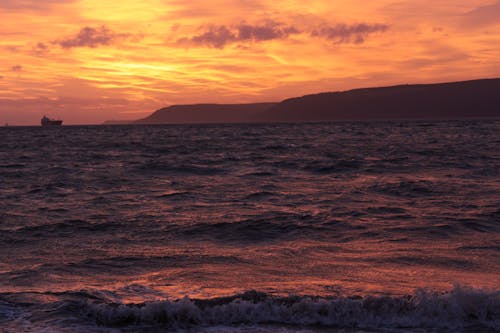 View of the Sea and Shore in Distance at Sunset 