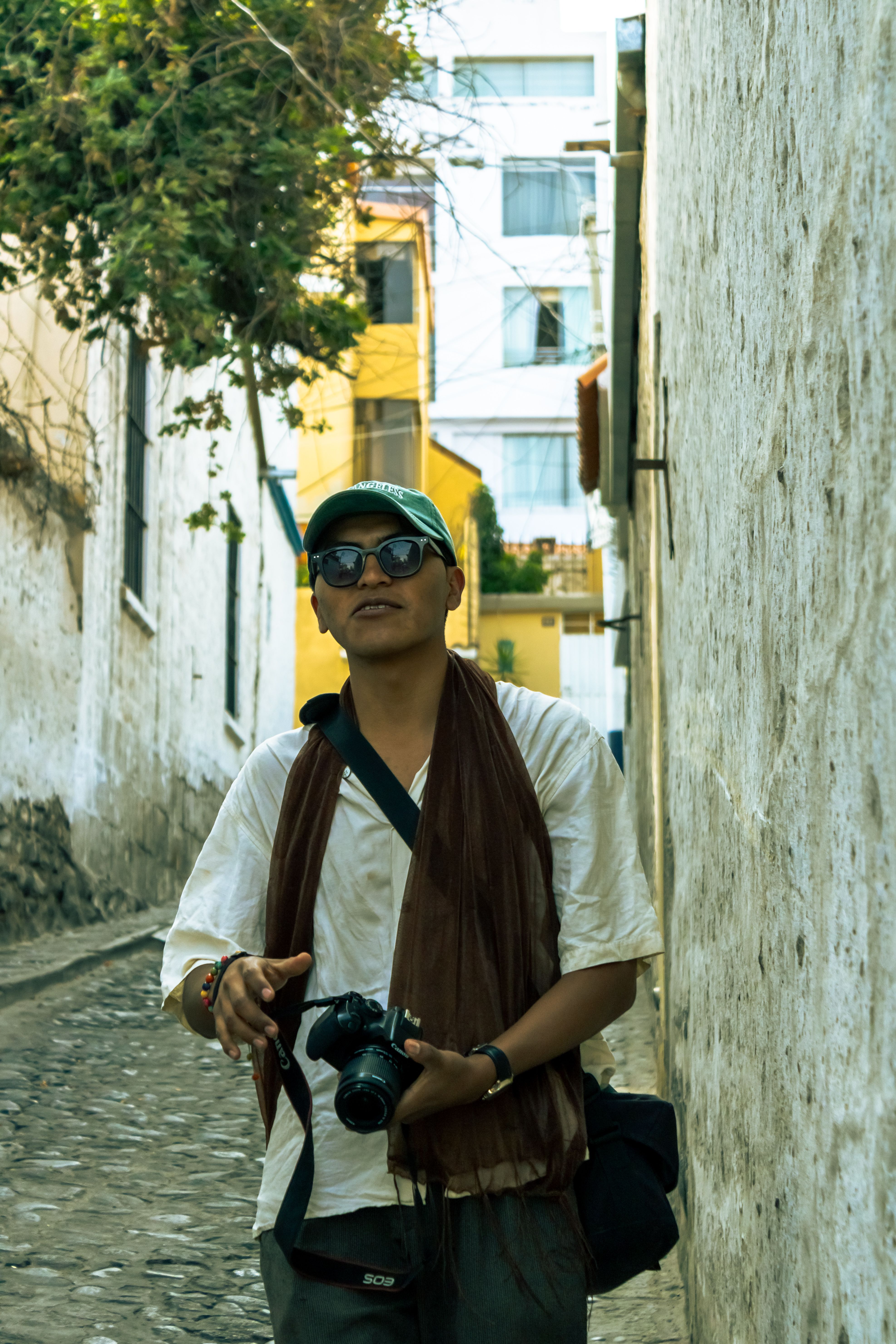 Man with camera strolling through cobbled streets of Yanahuara, Arequipa, Peru.