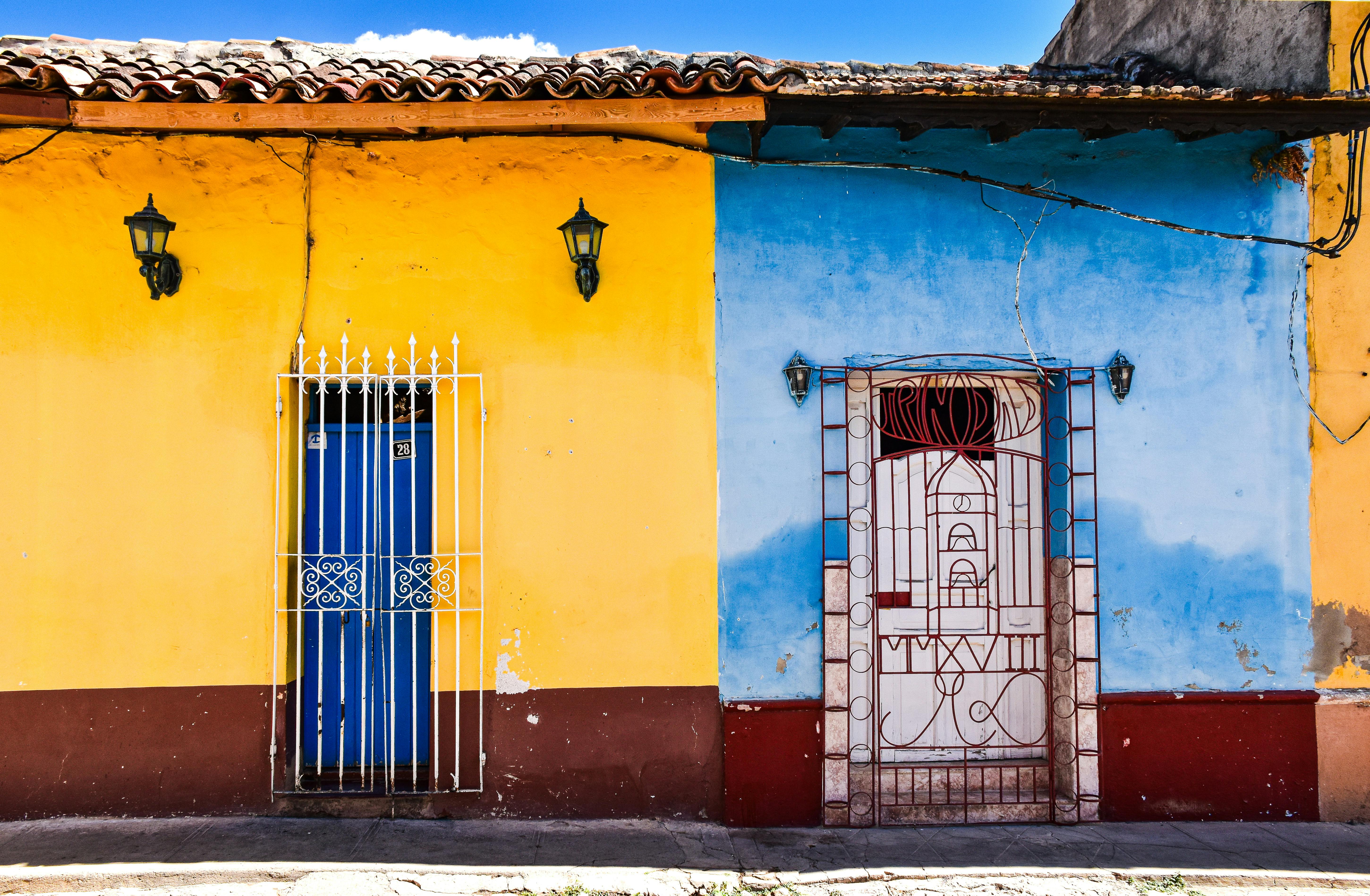 Colorful colonial-style walls with distinctive doors in an urban landscape.