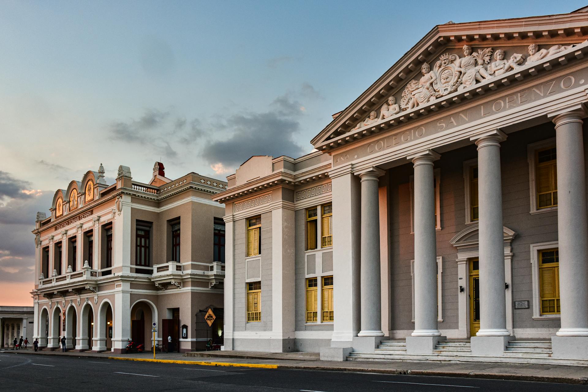 Elegant facade of Colegio San Lorenzo with classical architecture at sunset in Cienfuegos, Cuba.