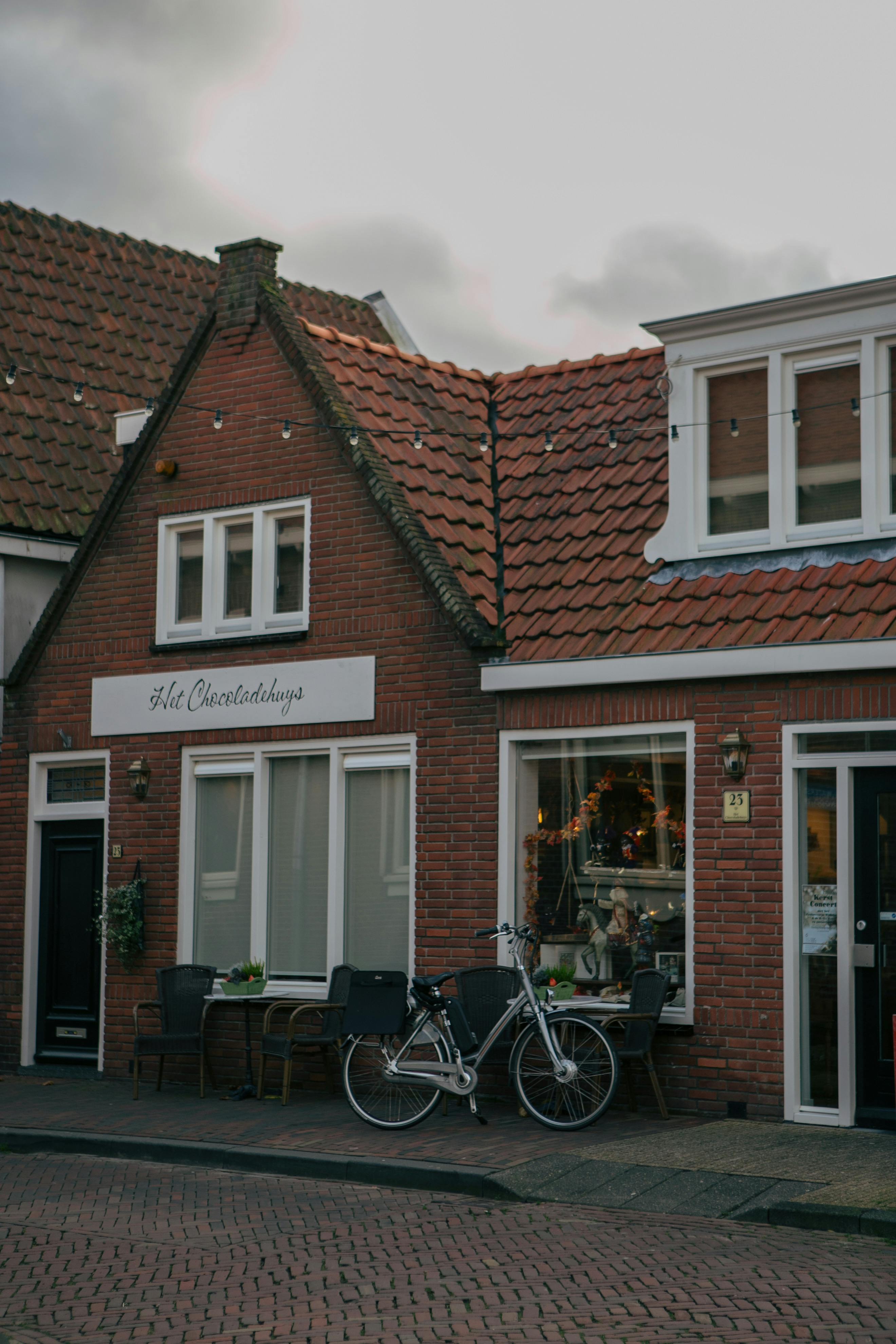 A picturesque view of a European café with a bicycle outside, embodying urban charm.