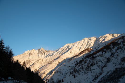 Stunning snowcapped mountains at Ponte di Legno, Italy, under a clear winter sky.