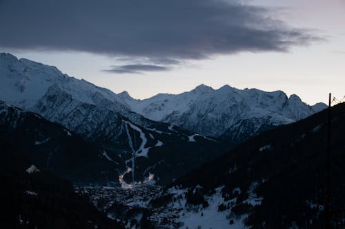 Village in a Valley Among Snow Covered Mountains