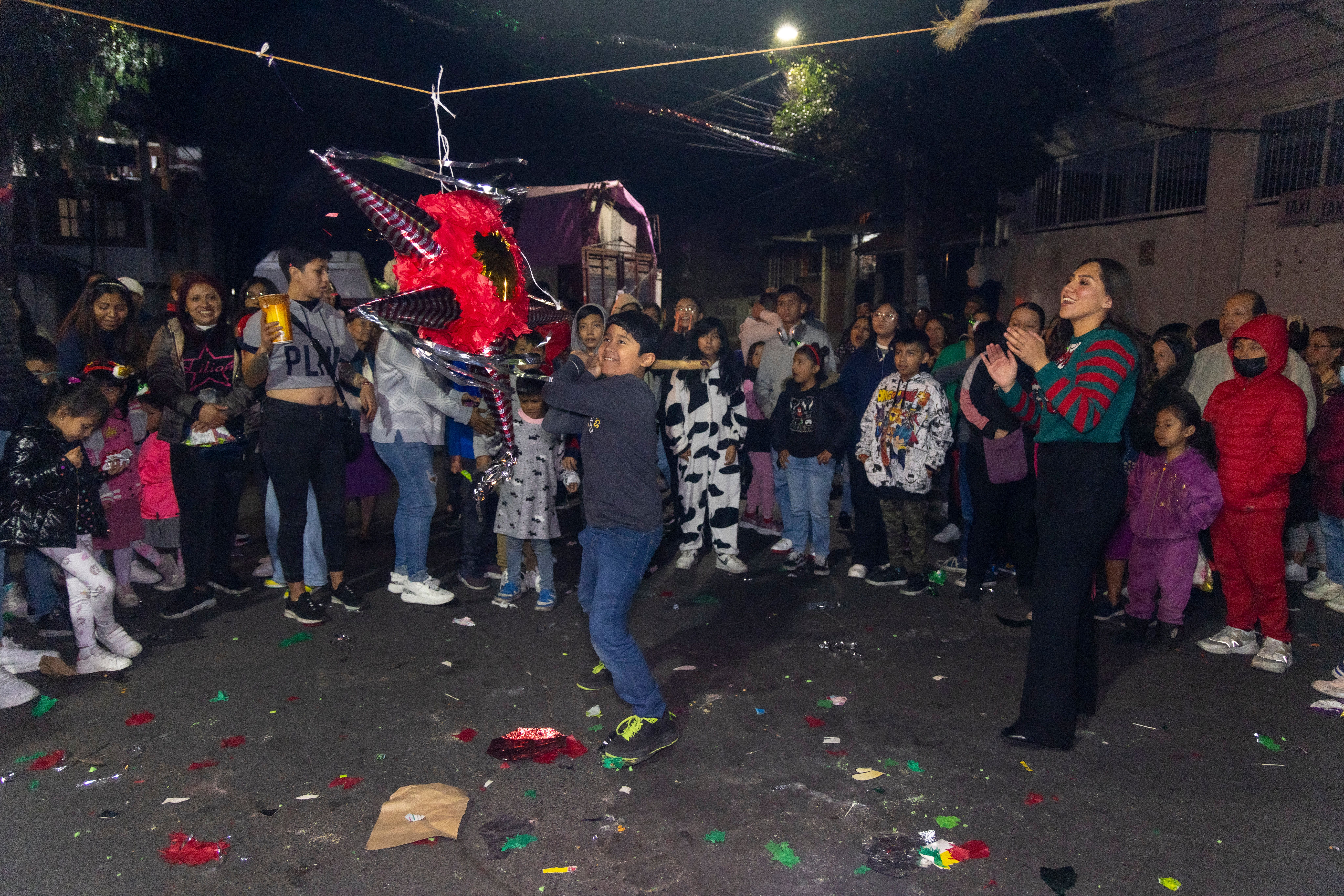 People Watching a Boy Hit a Pinata with a Stick · Free Stock Photo