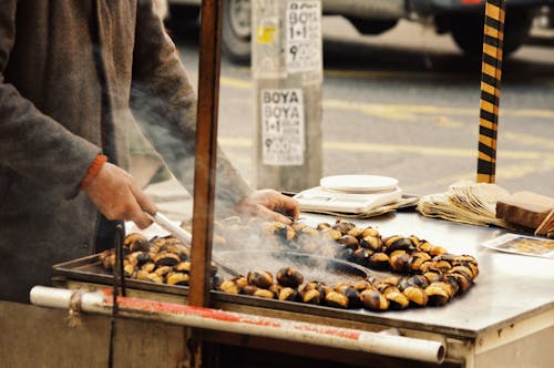 A Man Preparing Chestnuts on a Street Stall