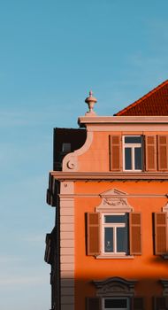 Stunning classic townhouse facade with ornate details illuminated by sunset sky.