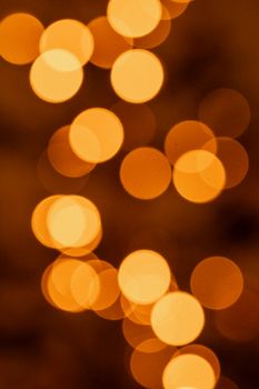 Soft, defocused warm lights creating a bokeh effect, perfect for backgrounds and abstract designs.