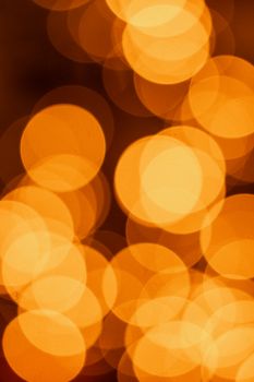A vibrant abstract image showcasing warm orange bokeh lights with a dreamy, defocused effect.