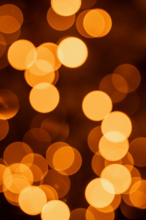 Free Abstract orange bokeh lights creating a warm, defocused background. Stock Photo