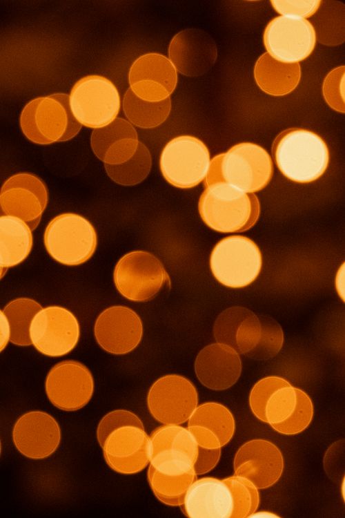 Free A captivating bokeh effect with golden lights perfect for creative designs and backgrounds. Stock Photo