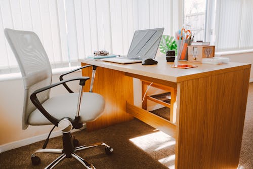 Free White Rolling Armchair Beside Table Stock Photo