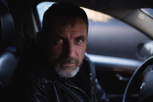 Man in Black Jacket Sitting Inside Car · Free Stock Photo