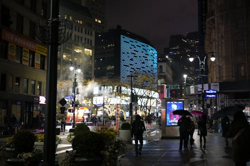 People on Sidewalk in Manhattan at Night